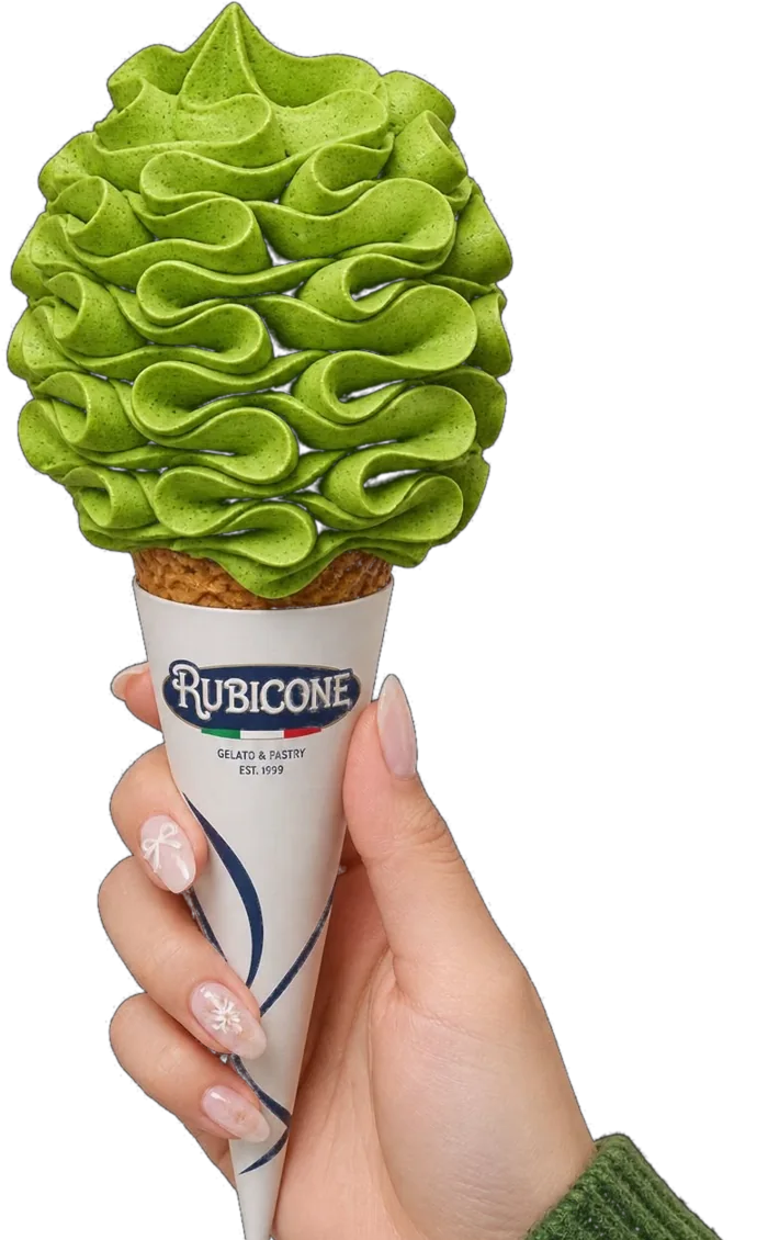 Takumi Ceremonial Matcha Soft Serve Mix 18 Hand holding a Rubicone cone piped with vibrant green matcha soft serve