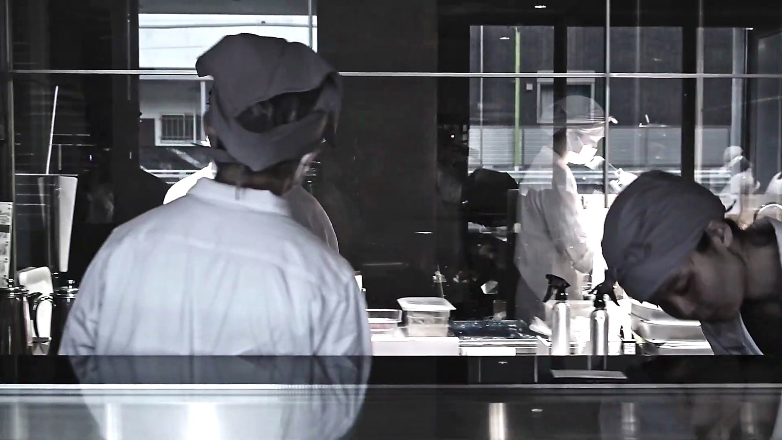 Pastry chefs at work behind the glass.