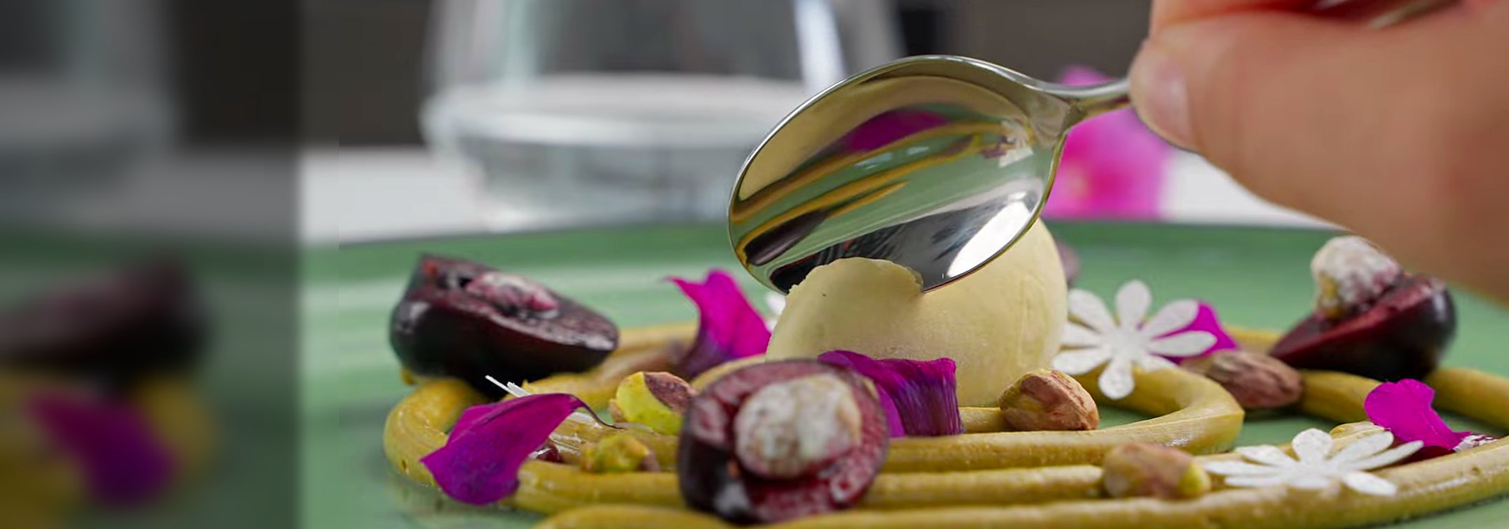 Gelato quenelle with figs, pistachio and edible flowers.