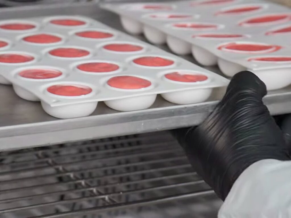 Trays of filled moulds going into a blast freezer