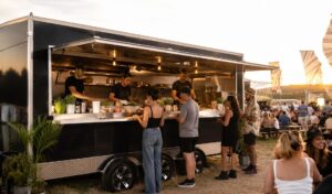 Food van serving customers at an evening event on quiet battery power