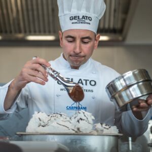 Gelato, Frozen Yoghurt & Soft Serve Machines, Ingredients & Display Cabinets 10 Gelato maker decorating a tub of gelato in a laboratory