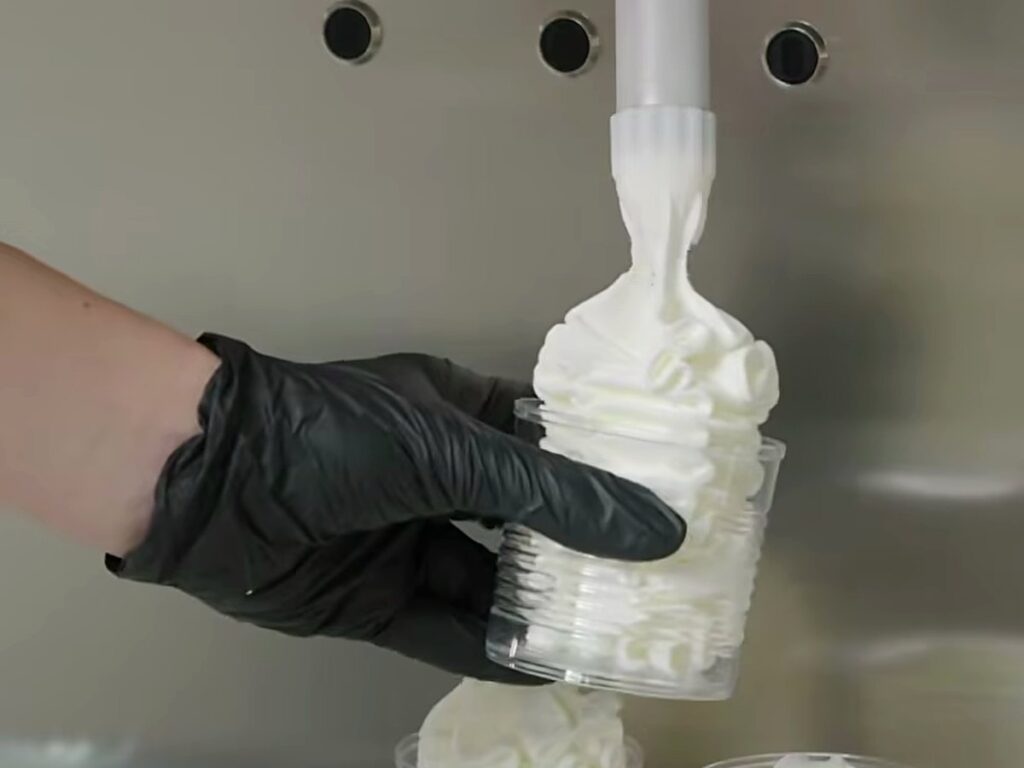 The Gelmatic Pastry Kit: Filling Tubs and Cups Straight from the Machine 11 Piping a single serve into a cup.