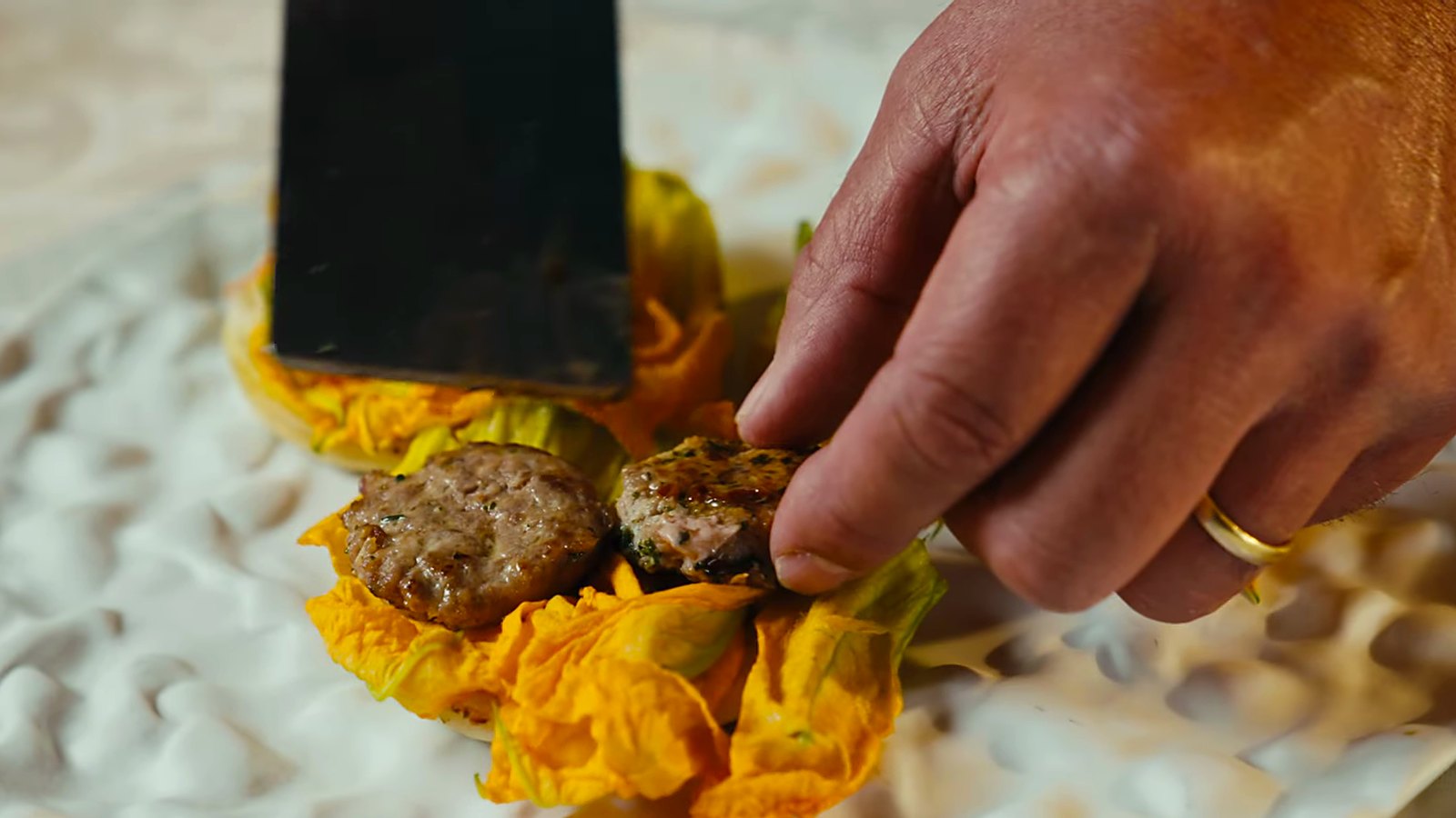 Duck patties placed on zucchini flowers.
